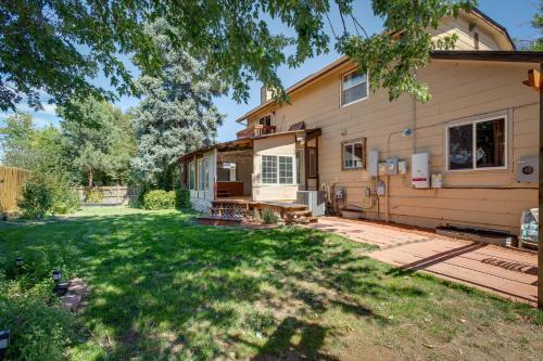 a home with a yard with a house at Spacious Aurora Retreat with Game Room and Hot Tub! in Aurora