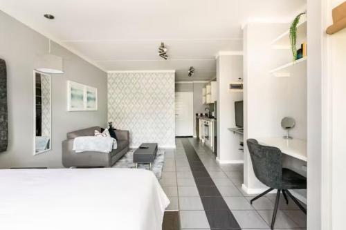 a bedroom with a bed and a living room at Lea's Furnished Apartments - Dainfern in Sandton
