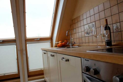 a kitchen with two sinks and a bottle of wine at Ferienwohnung Rundumblick in Sassnitz