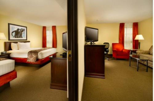 a hotel room with a bed and a television at Hotel Lotus Kansas City Merriam in Merriam