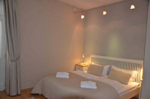 a bedroom with a white bed with two towels on it at Fürstenhof - Ferienwohnung 203 in Sassnitz