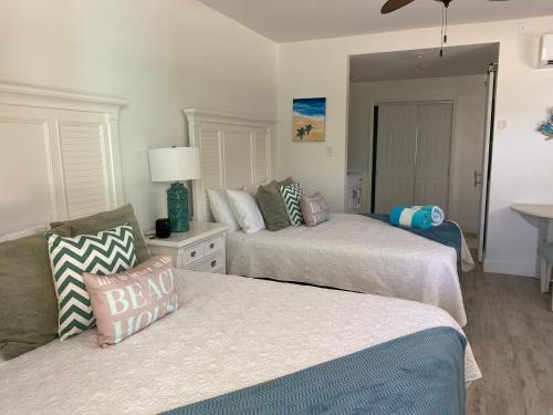 a bedroom with two beds and a table at The Turtle Nest at Cottages in Sand Bluff