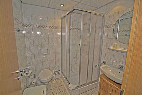 La salle de bains est pourvue d'une douche, de toilettes et d'un lavabo. dans l'établissement Villa Seeblick Apartment 307, à Sassnitz