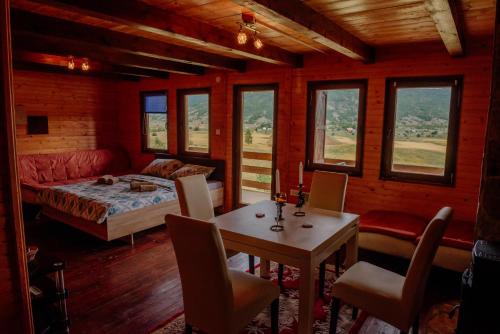 a bedroom with a bed and a table and chairs at Villa Forestside in Pluzine