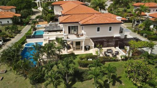 an aerial view of a house with a swimming pool at Luxury Villa In Prestigious Pristine Bay, Home Of The Black Pearl Golf Course in French Harbour