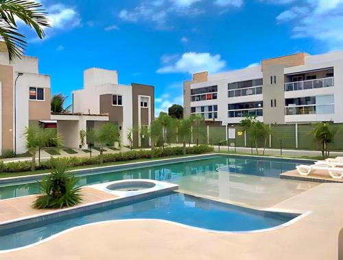 a swimming pool in front of a building at Casa Solar - Praia do Francês in Marechal Deodoro