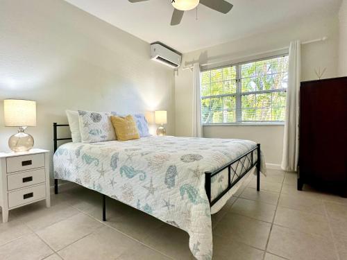 a bedroom with a large bed and a window at Snug Harbour View Condo #5 in George Town