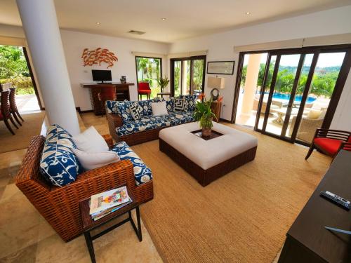 a living room with a couch and a chair at Pearl Court 1111 at Pristine Bay in French Harbour