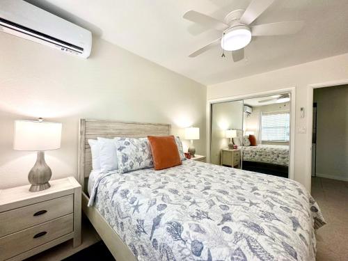 a bedroom with a bed and a ceiling fan at Snug Harbour View Condo #2 in George Town