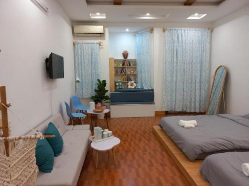 a living room with two beds and a couch at Đất Cảng Homestay in Hai Phong