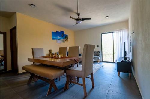 a dining room with a wooden table and chairs at Condo Temis Vallarta in Puerto Vallarta