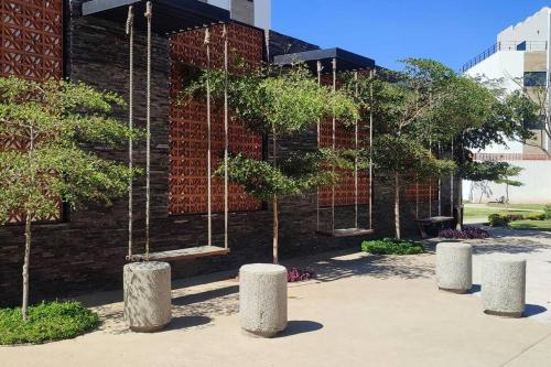 a brick building with trees in front of it at Condo Temis Vallarta in Puerto Vallarta