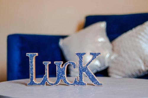 a table topped with blue sequined initials on a bed at Condo Temis Vallarta in Puerto Vallarta