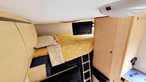 vista interna di una piccola camera da letto in un camper di Camping-car a Vitry-le-François