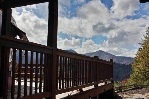 a view from the porch of a cabin with a view of the mountains at Cherokee @ Sky Ridge Yurts in Bryson City