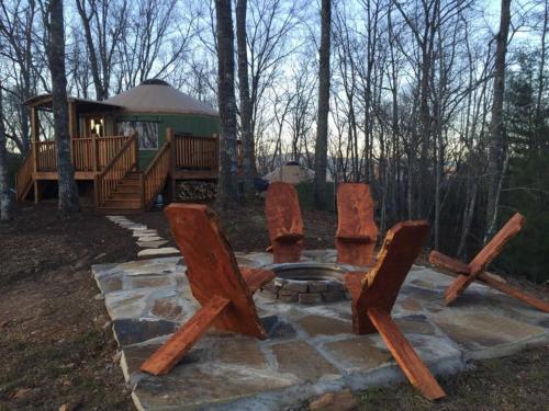 a group of chairs sitting in front of a cabin at Cherokee @ Sky Ridge Yurts in Bryson City