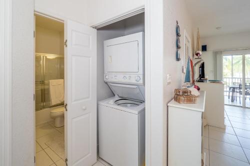 a white laundry room with a washer and dryer at Kaibo Sunset Condo in Driftwood Village