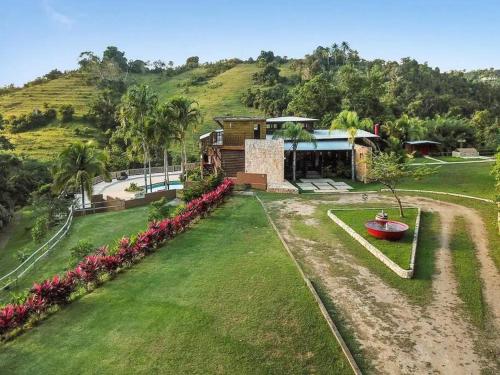 an aerial view of a house with a yard at 3 bed 2 bath W pool @ Juncos in Canovanas
