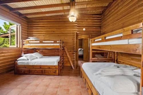 a bedroom with two bunk beds in a wooden cabin at 3 bed 2 bath W pool @ Juncos in Canovanas