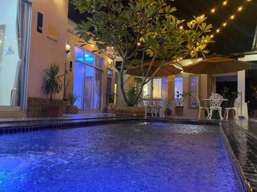 a swimming pool in a house with a blue lighting at Suria 3 Sepang with private pool in Sungai Pelik