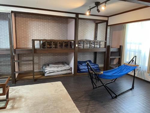 a room with a hammock in the middle of a room at Koniyado Room 101 - Vacation STAY 42374v in Setouchi