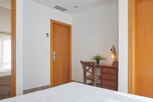 a bedroom with a bed and a desk and a door at Leizarooms in Leitza