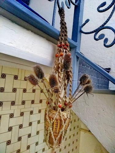a hanging basket with dried flowers on a wall at Двухуровневая квартира студия - Duplex studio apartment in Dushanbe