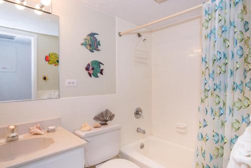 a bathroom with a sink and a toilet and a shower at Cocoplum #5 Condo in George Town