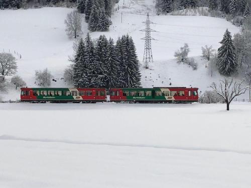 a red and green train in the snow at Chalet-Prinz-Murau-Kreischberg in Murau
