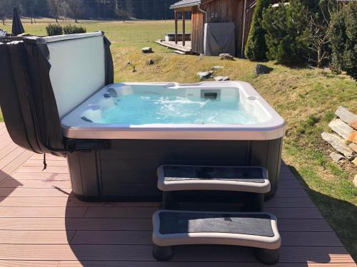 a jacuzzi tub sitting on a deck at Chalet-Prinz-Murau-Kreischberg in Murau
