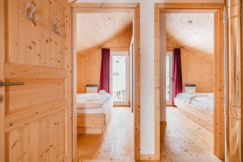 a room with two beds and a door at Chalet-Prinz-Murau-Kreischberg in Murau