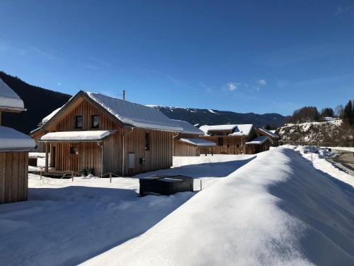 a group of wooden buildings in the snow at Chalet-Prinz-Murau-Kreischberg in Murau
