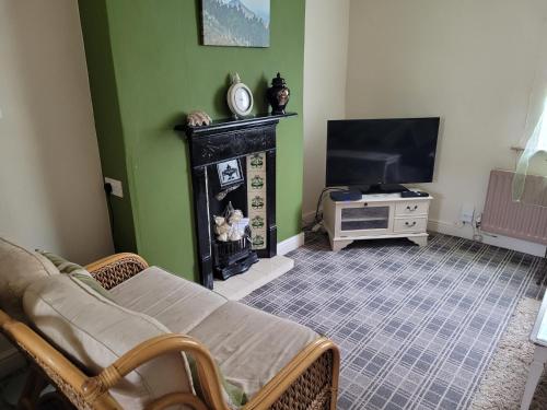 a living room with a flat screen tv and a couch at No 35 Guisborough - 2 bedroom house in Guisborough