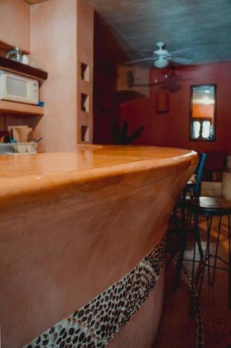 a bar with a wooden counter top in a room at Casabu in Zihuatanejo