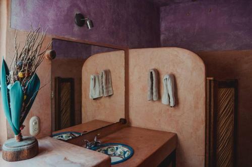 een badkamer met een wastafel en een spiegel bij Casabu in Zihuatanejo