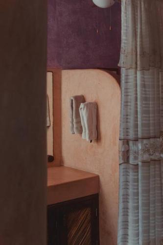 a bathroom with a mirror and a wooden table at Casabu in Zihuatanejo