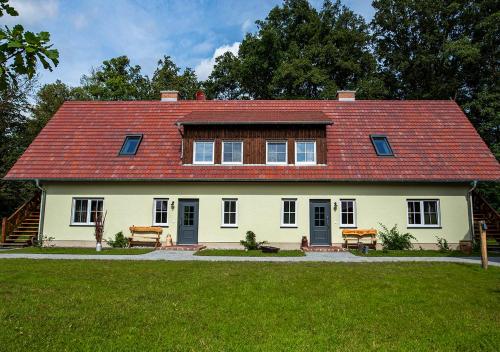 a large white house with a red roof at Vierseitenhof Appartements in Burg