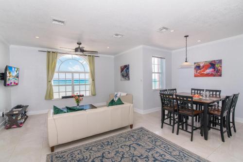 a living room with a couch and a table at Cayman Paradise Villa #1 in Sand Bluff