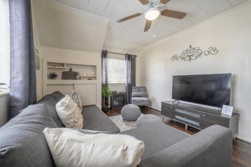 a living room with a couch and a flat screen tv at Seminole Heights - Foodie Capital of Tampa in Tampa