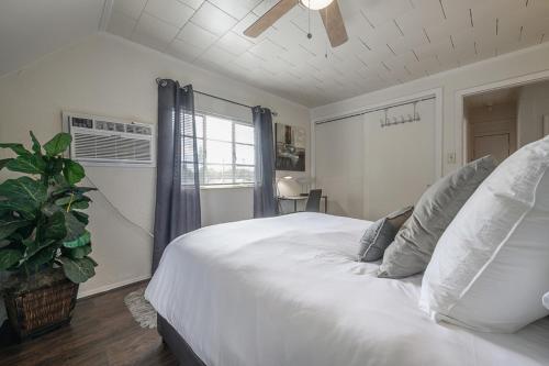a bedroom with a large white bed and a window at Seminole Heights - Foodie Capital of Tampa in Tampa