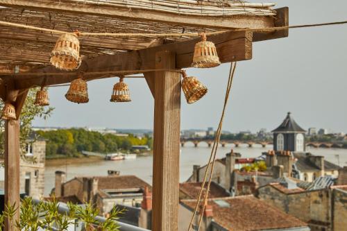 a view of a river from a balcony with chandeliers at Hotel Indigo Bordeaux Centre Chartrons by IHG in Bordeaux