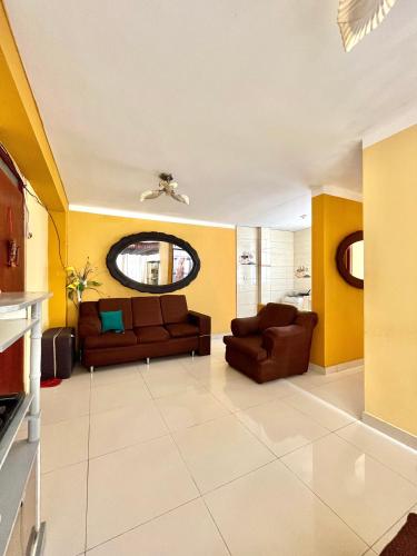 a living room with two couches and yellow walls at CASA LARA - Departamento equipado, 2 dormitorios in Lima