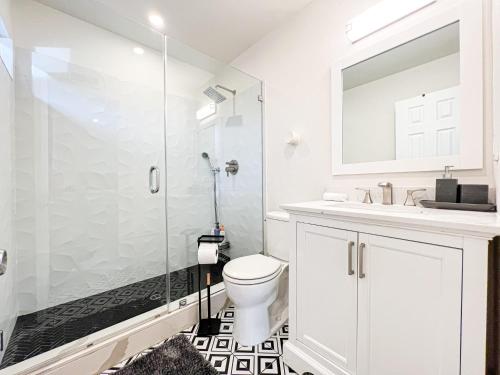 a bathroom with a toilet and a glass shower at Gorgeous 4BR House with Swimming Pool in Topanga