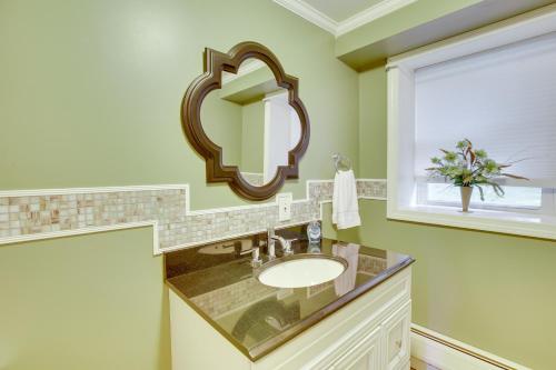 een badkamer met een wastafel en een spiegel bij Waterville Home Rental with Private Yard and Deck! in Waterville