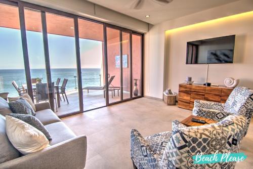 a living room with a view of the ocean at Casa del Mar Bucerias - Beachfront Condos in Bucerías