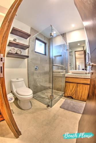 a bathroom with a toilet and a shower and a sink at Casa del Mar Bucerias - Beachfront Condos in Bucerías