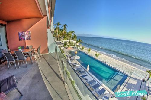 a resort balcony with a swimming pool and the ocean at Casa del Mar Bucerias - Beachfront Condos in Bucerías