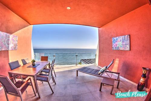 a dining room with a table and chairs and the ocean at Casa del Mar Bucerias - Beachfront Condos in Bucerías