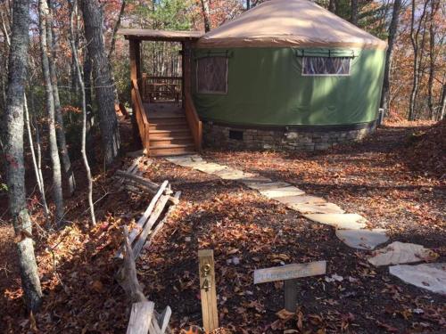 einen Pavillon im Wald mit einer Holztreppe in der Unterkunft Tuckaseegee @ Sky Ridge Yurts in Bryson City