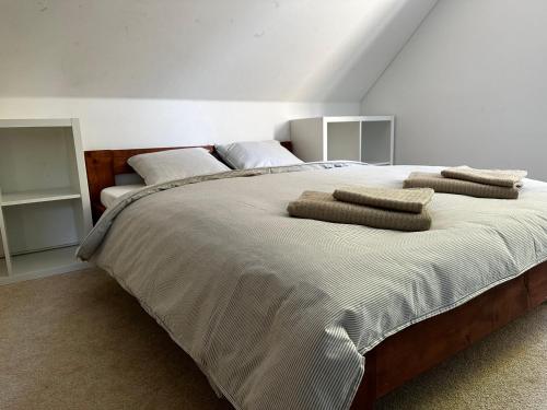 a bedroom with a large bed with two pillows on it at Moderní dům s bazénem a saunou, Žďárské vrchy in Malá Losenice